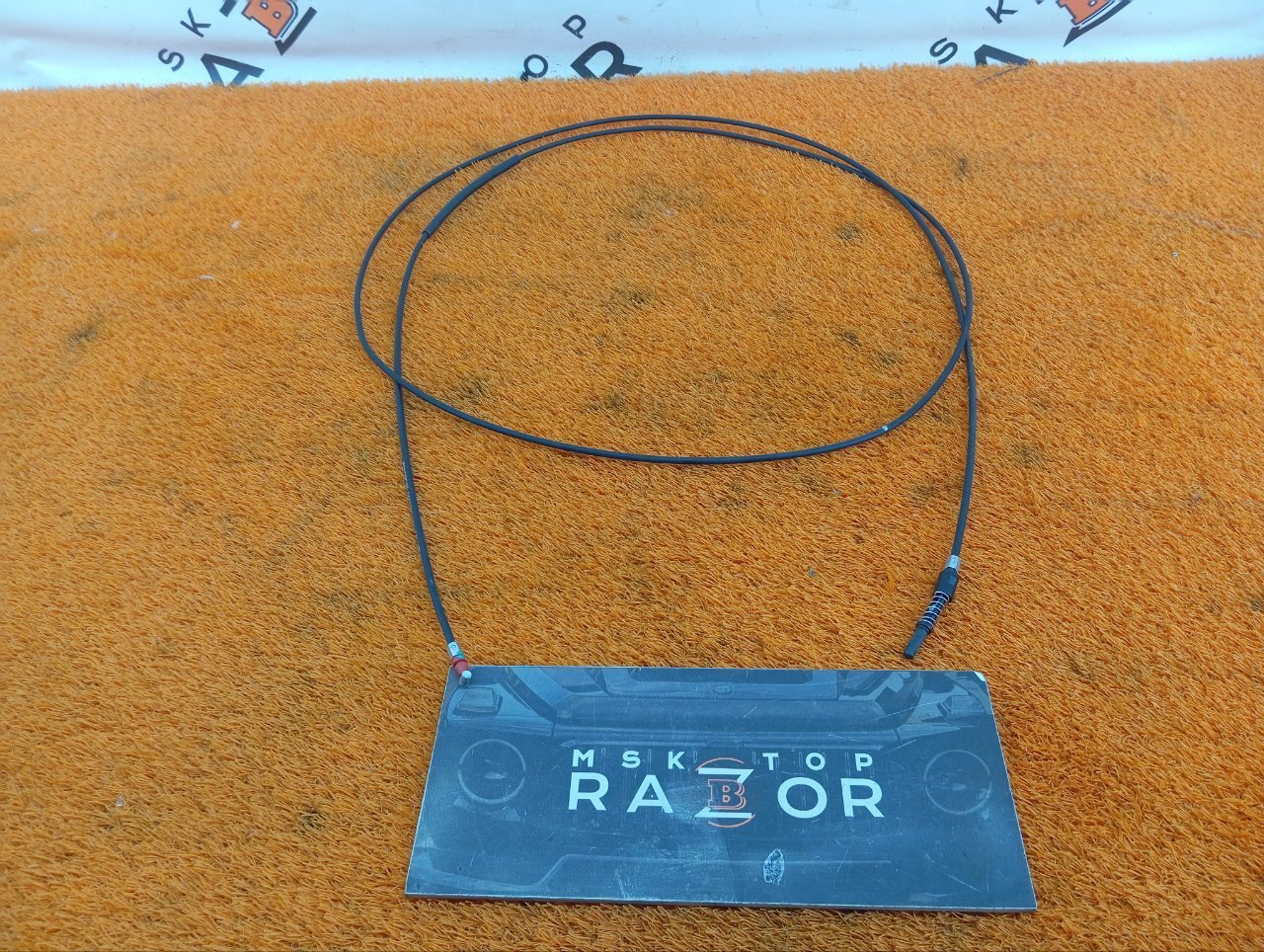 Трос лючка топливного бака